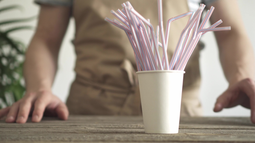 Plastic disposable straws for coffee and cocktails. We replace harmful plastic with items that do not harm the environment. Garbage that damages the environment Royalty-Free Stock Footage #1072089019