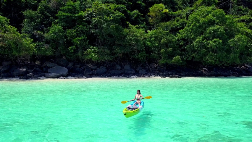 Cute Asian Girl on a Kayak at Monkey Beach, Phi Phi Island, Thailand. Drone. | Shutterstock HD Video #1072095122