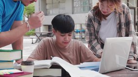 A happy group of attractive young people is tutoring exams with study books, sitting on the study table. Student group and tutoring education concept. - Powered by Shutterstock - Get 15% off with code: PIKWIZARD15