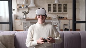 Caucasian woman indoor happy excited sit on sofa in virtual reality glasses playing games cheerful   