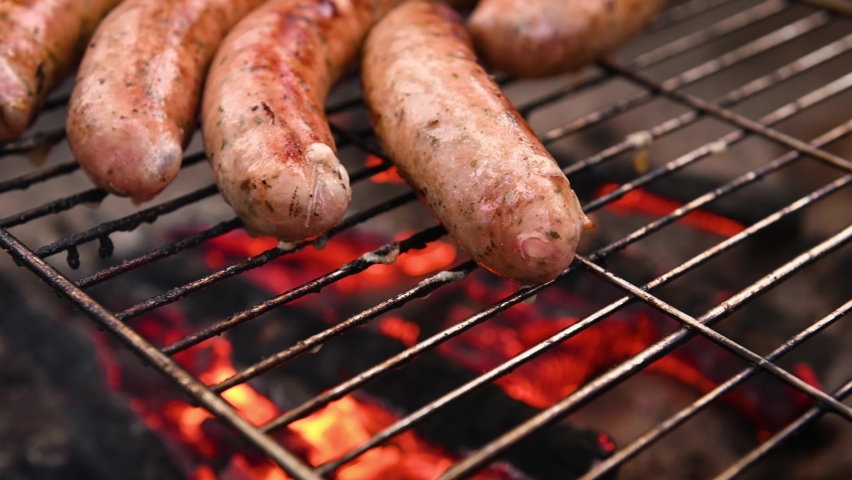 Sausage Bratwurst on the grill with flames Royalty-Free Stock Footage #1072104752