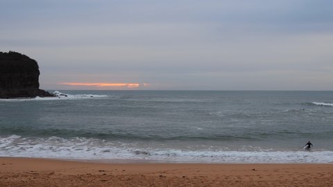 Headland and sunrise over Pacific on Mona Vale beach in Sydney as 4k.
