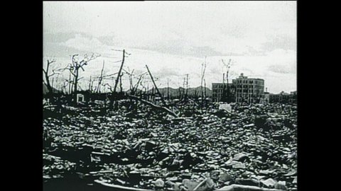 1940s: Decimated city of Hiroshima. Headline of newspaper "Atomic Bomb Spells Japan Ruin: Truman". Butcher talks to female customer over counter.
