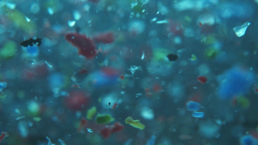 Global ocean pollution - microplastic in water. recycling concept plastic background. plastic fragments or particles in ocean. single use plastics | Shutterstock HD Video #1072123154