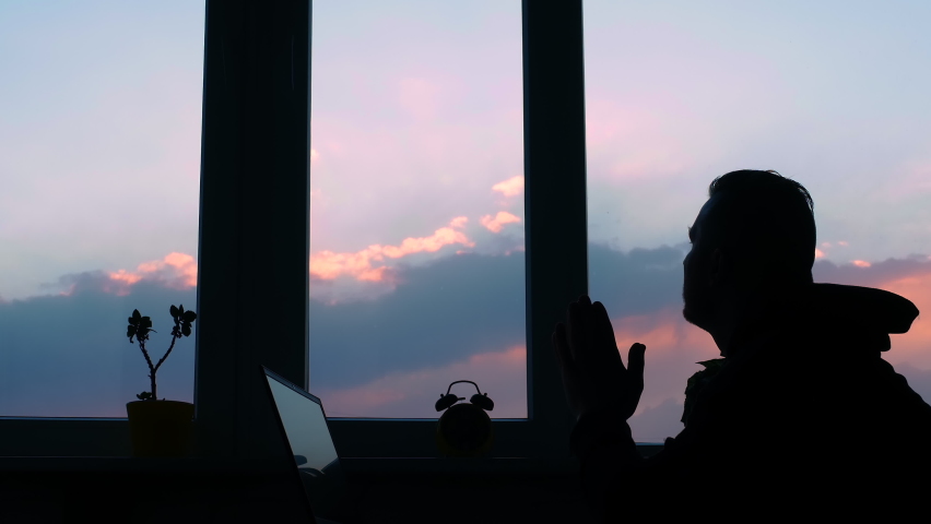 Desperate man at his desk, depression. Silhouette of a man tired at sunset. Human social problems. Bankrupt in business, problems at work. | Shutterstock HD Video #1072132631