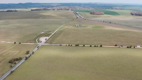 Dolly forward drone shot of Stonehenge towards A303 highway
