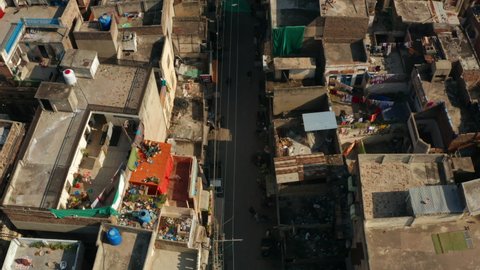 People Walk At Narrow Street Of A Town On A Sunny Day At Rawalpindi, Pakistan. - aerial