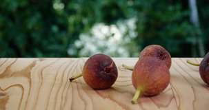 Video of figs placed on a board and taken by dolly.