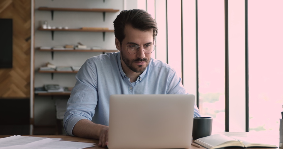 Angry stressed man office manager in glasses looks at laptop screen shocked by breakdown or operating system virus problems, unexpected error, data loss, annoyed with device stuck, need repair concept Royalty-Free Stock Footage #1072143560