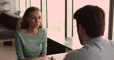 Applicant passes job interview talk to company HR manager in office, during recruiting smiling woman feels confident give answers to questions applying for position. Staffing, human resources concept