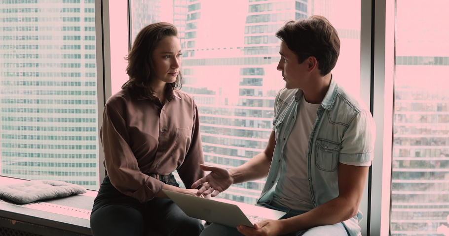 Millennial business partners discuss project presentation on laptop in modern office skyscrapers succeed common decision making deal shake hands. Successful negotiations, reach an agreement concept Royalty-Free Stock Footage #1072143716