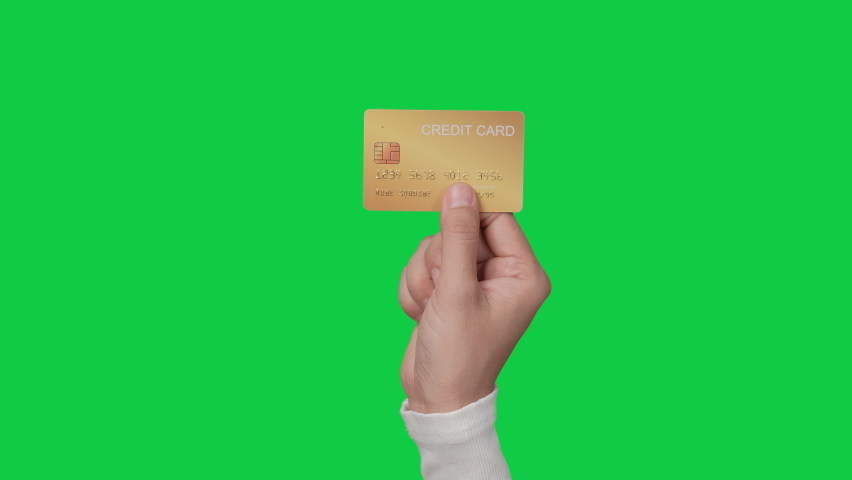 Woman customer hands holding credit card on chroma key green screen background.