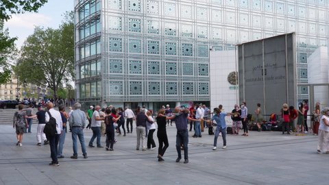 Paris, France - May 09 2021: Parisians dancing in the streets in front of the Institut du Monde Arabe during third Covid-19 lockdown in France.