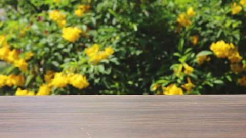 Wooden top table with bokeh and blur green garden on background, blur background , Copy space