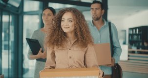 Comeback to office people, Young business people of mixed-races with boxes come back to office. Colleagues going to work in modern workspace. teamwork together. 4k Slow motion video.