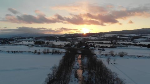 Aerial View Drone footage in Hokkaido Japan sunset while snowing