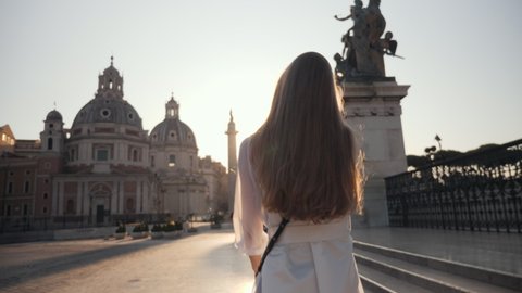 Portrait of Young Tourist woman exploring European town at sunrise