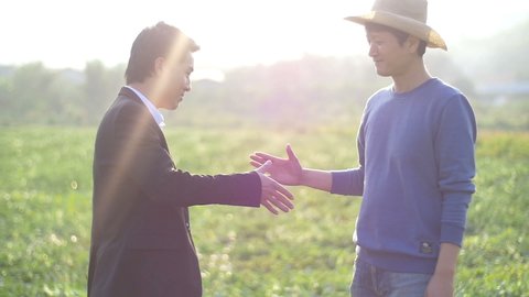 Farmer And Businessman Shaking Hands, Partners
