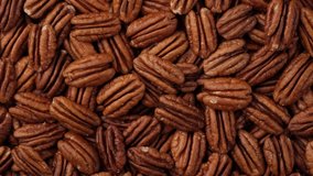 pecan nuts top view, rotation. Healthy food concept. 4K UHD video