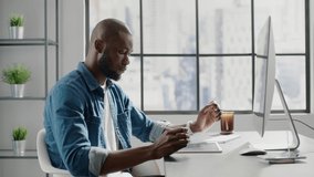 Afro-american bearded freelancer with crew cut draws scheme on tablet in office room against window with city outside slow motion - Powered by Shutterstock - Get 15% off with code: PIKWIZARD15
