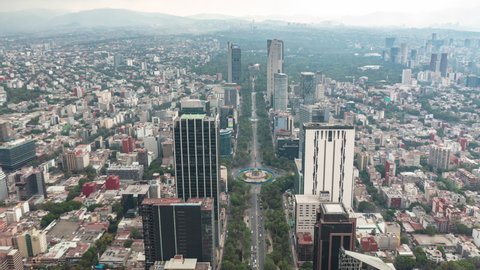Aerial hyperlapse of busy car traffic in between Skyscrapers of modern urban metropolis city center in Mexico City, Drone Motion Time Lapse forward flight
