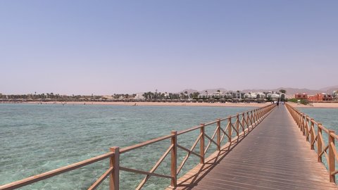 Wooden jetty bridge above turquoise tropical sea, Sharm El Sheikh, pan