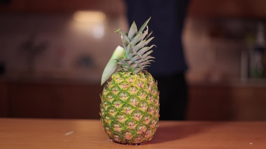 Slicing up a pineapple with an axe strike Royalty-Free Stock Footage #1072197257