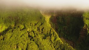 Aerial view of waterfall flowing between rocks Poco Ribeira do Ferreiro, Alagoinha, Flores Island, Azores, Portugal, Europe. Iconic mountains covered green vegetation, 4k footage