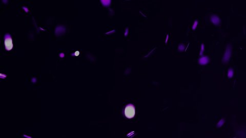 A flurry of purple sparkles an bokeh balls for film overlay and special effects. 4k.