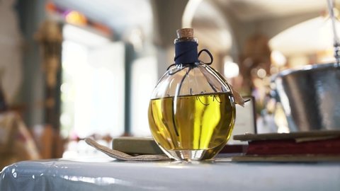 Close up, a bottle of the baptism oil in the church.