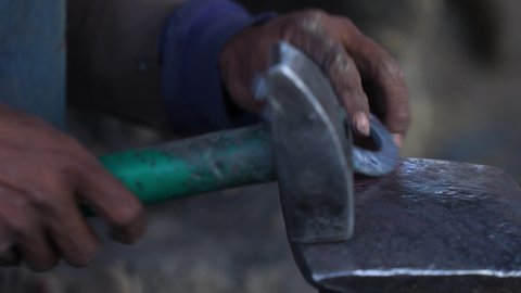 Blacksmith Hammers A Horseshoe To Straighten It In A Workshop At Bamyan, Afghanistan - close up