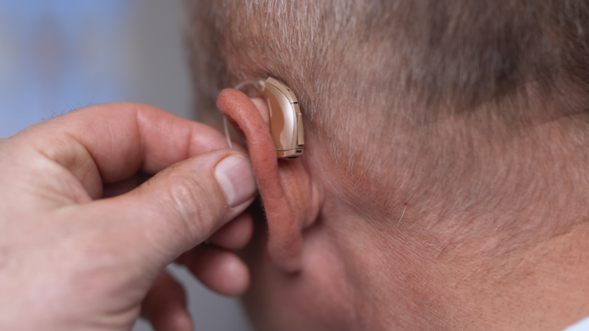 Man wears a hearing aid. Senior man with symptom of hearing loss. Mature tensed man with fingers near ear. Man with hearing aid. | Shutterstock HD Video #1072214336