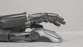 Man with bionic prosthetic hand working on laptop or computer, close-up finger of artificial hand pressing mouse button. - Powered by Shutterstock - Get 15% off with code: PIKWIZARD15