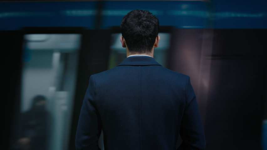 Back view of male entrepreneur in formal wear standing on metro station with moving train on background. Missing of public transport concept. | Shutterstock HD Video #1072220189