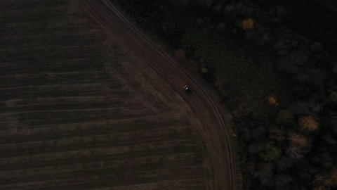 Aerial camera follows the car at dusk