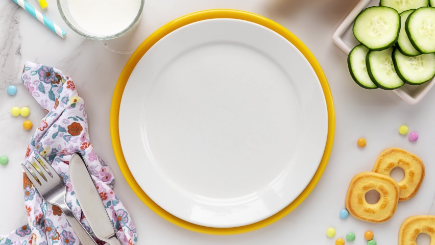 Stop motion animation of making a cute cheese sandwich with salad and cucumbers for a healthy lunch or breakfast for kids