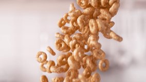 Crunchy Circle-Shaped Whole Grain Cereals Falling Down in a Batch in Slow Motion and Macro - Powered by Shutterstock - Get 15% off with code: PIKWIZARD15