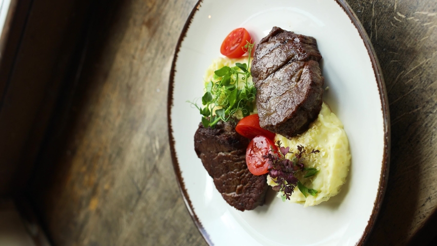 Vertical Screen 4K Grilled pork with mashed potatoes on plate. a restaurant