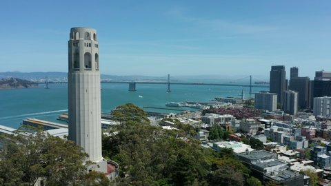 flying clockwise around Coit Tower with San Francisco passing in Bird