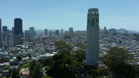 flying counter clockwise around Coit Tower with San Francisco passing in Bkrd