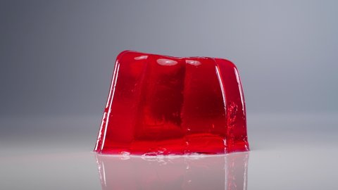Wobbly single red jelly on white background. 