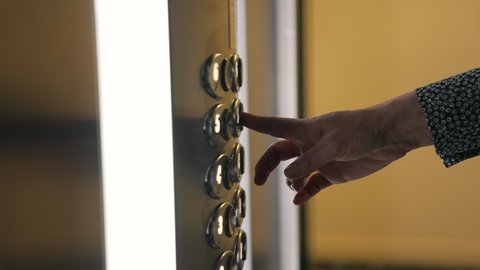 Man's female hand presses elevator button to move up.Movement to success, career. index finger of hand presses elevator button, closing door. concept of success, career growth, upward advancement man.