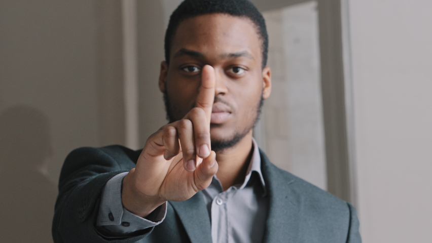 Young African American lawyer in suit man standing in office waving index finger showing NO gesture. People rights protection, domestic violence abuse rejection, no discrimination, keep distance  Royalty-Free Stock Footage #1072248266