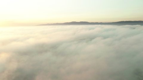 Aerial Shot Of Cloudscape Near Mountains Against Sky At Sunset, Drone Flying Forward Towards Mountain Range - Los Angeles, California