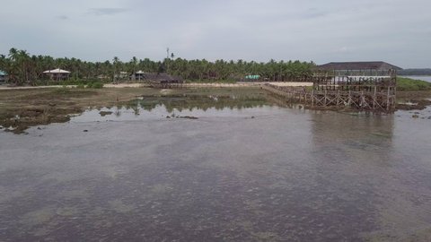 Aerial Shot Of Marsh At Beach Against Sky, Drone Flying Forward Over Water - Siargao, Philippines