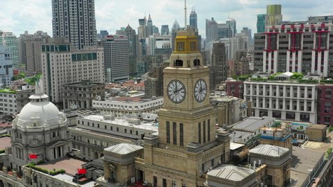 Aerial Panning Shot Of Popular Clock Tower Amidst Buildings In City, Drone Flying Near Landmark Against Sky - Shanghai, China