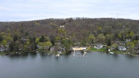 Summer time lake side village in USA, drone footage around lake real estates. 