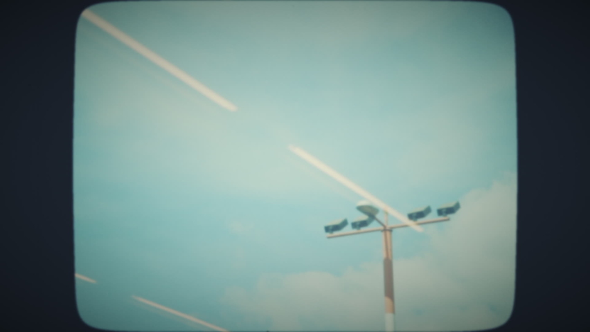 Pole with projector lights at the airport, view from the window. Vintage Film Look.