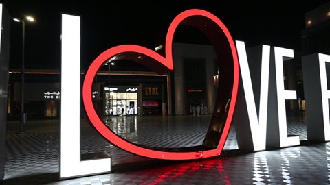 Riyadh, Saudi Arabia – May 10th 2021: I love Riyadh large icon or logo in open strip malls. Night videography, slow motion.