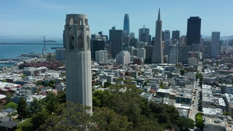 Descending and tilting up shot of Coit Tower revealing San Francisco skyline